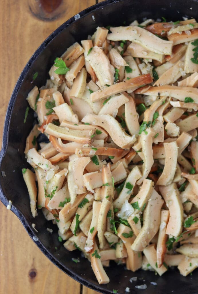 Golden sautéed chicken of the woods mushrooms topped with chopped parsley.